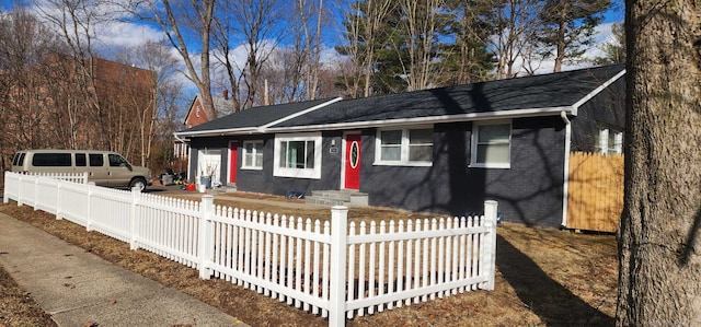 view of front of property with a fenced front yard and brick siding