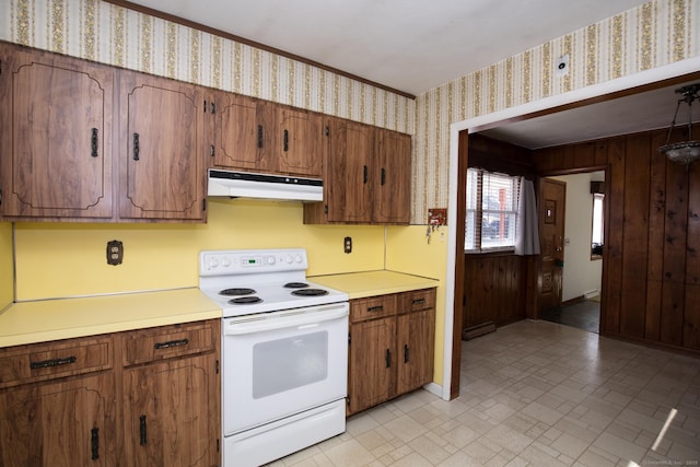 kitchen featuring white electric range oven, wallpapered walls, light countertops, under cabinet range hood, and baseboard heating