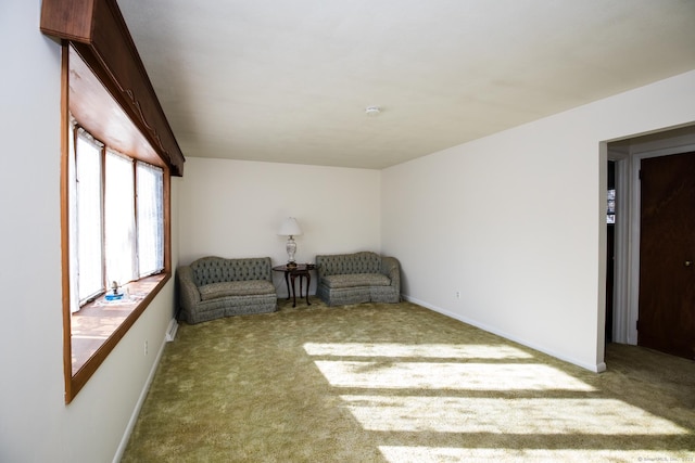 living area with baseboards and carpet floors