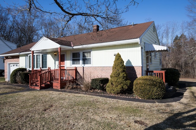 ranch-style home with a front yard, an attached garage, brick siding, and a chimney