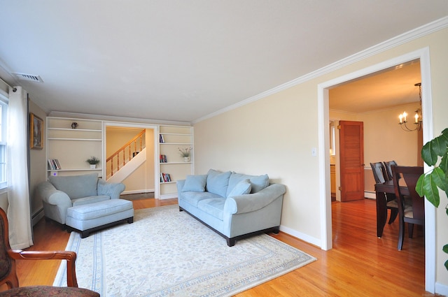 living area with crown molding, visible vents, stairway, light wood-style floors, and a chandelier