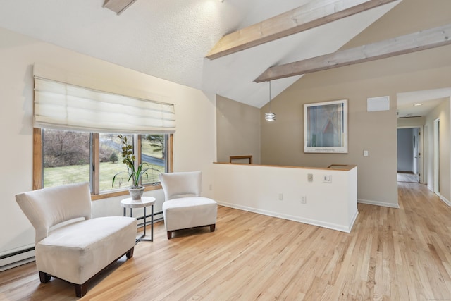 sitting room featuring vaulted ceiling with beams, baseboards, a baseboard heating unit, and wood finished floors