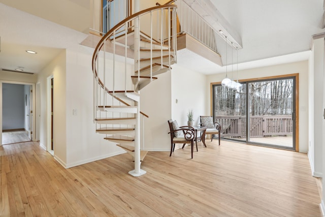 stairs with baseboards and wood finished floors