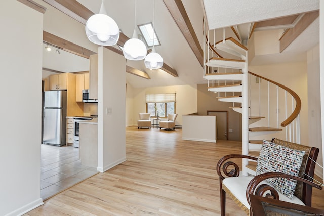 interior space featuring stairway, rail lighting, light wood-style flooring, and baseboards