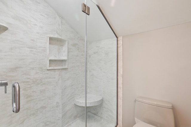 full bath featuring a stall shower, lofted ceiling, and toilet