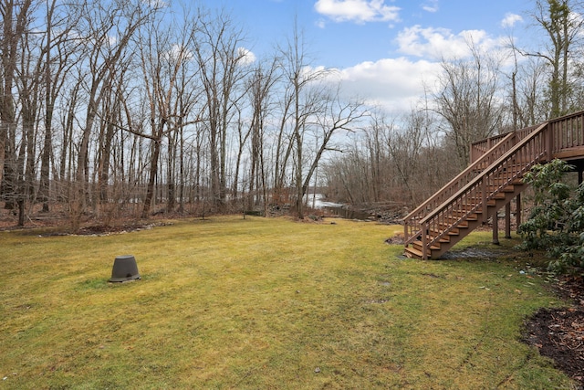 view of yard featuring stairway and a deck