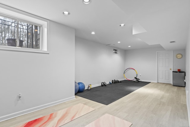 exercise area featuring recessed lighting, wood finished floors, visible vents, and baseboards