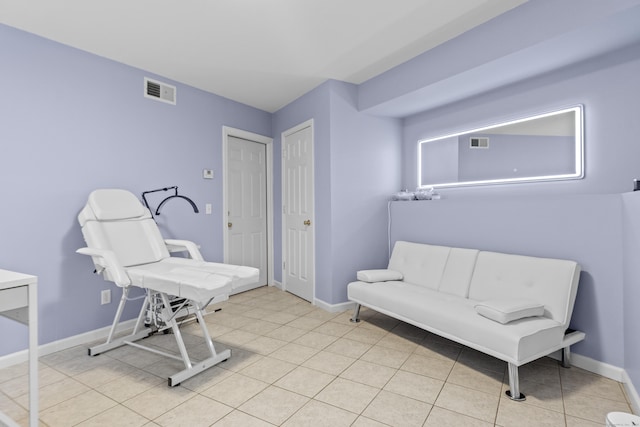 sitting room featuring visible vents, baseboards, and light tile patterned floors