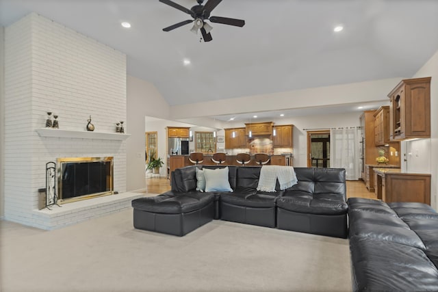 living area with lofted ceiling, ceiling fan, a brick fireplace, and recessed lighting