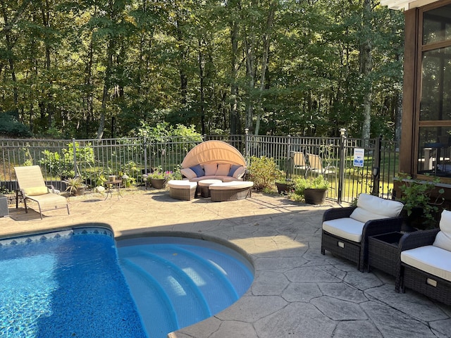 view of swimming pool featuring a patio area, fence, and a fenced in pool