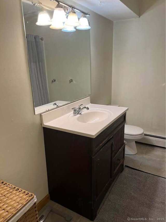 bathroom with tile patterned floors, a baseboard radiator, toilet, and vanity