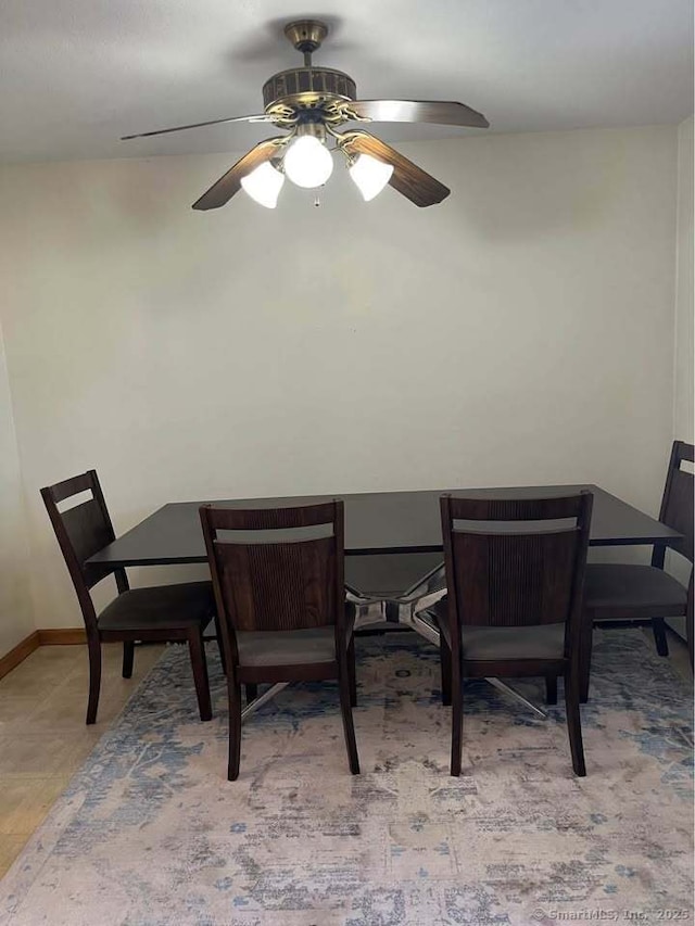 dining room featuring baseboards and ceiling fan