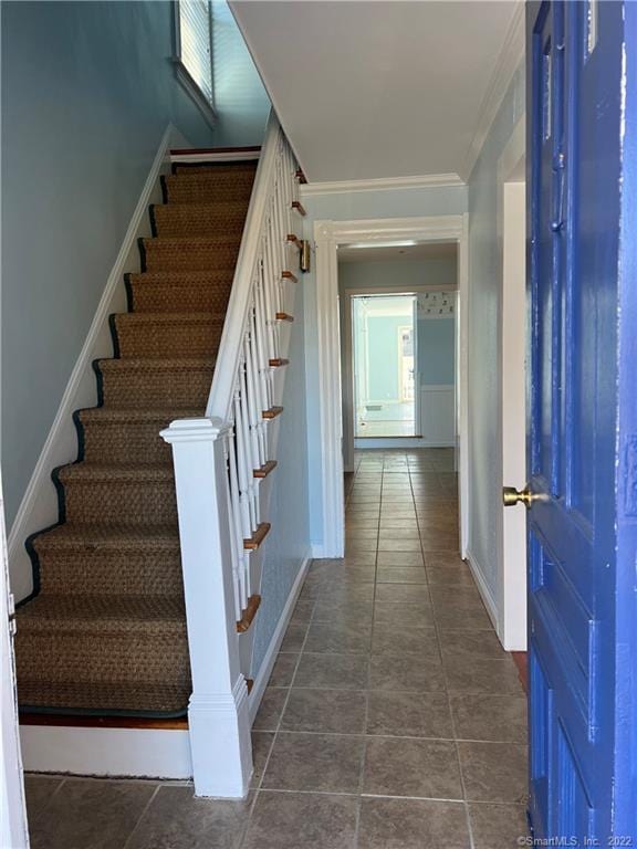 stairway featuring tile patterned floors and baseboards