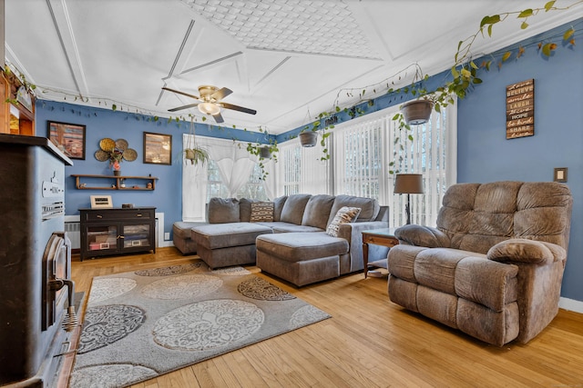 living room with hardwood / wood-style flooring and a ceiling fan