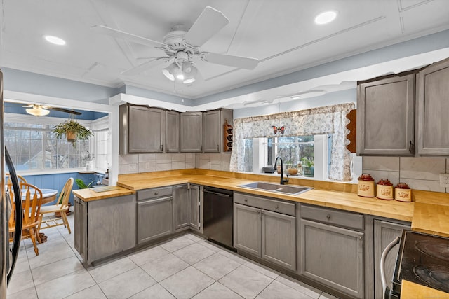 kitchen with range with electric cooktop, a sink, wood counters, black dishwasher, and decorative backsplash