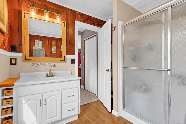 full bathroom featuring a stall shower, wood finished floors, and vanity