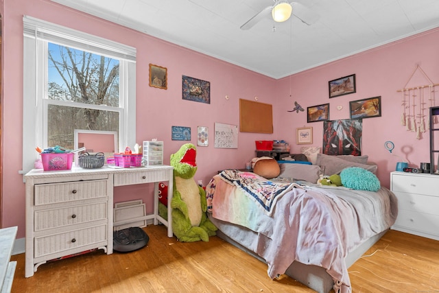 bedroom featuring a ceiling fan and light wood finished floors