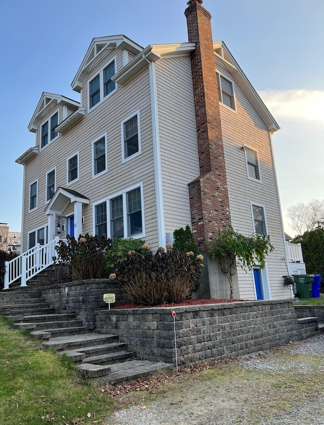 view of front facade featuring a chimney