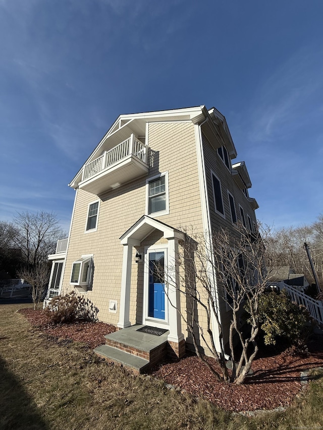 exterior space with a balcony and a wall unit AC