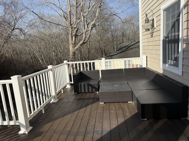 wooden terrace with an outdoor hangout area