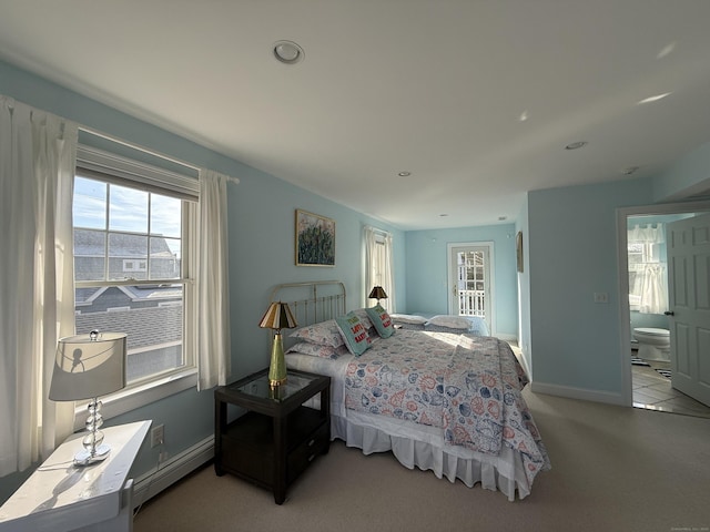 bedroom featuring baseboards, baseboard heating, and carpet flooring