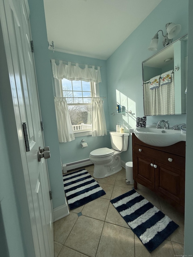 full bath featuring toilet, vanity, baseboards, baseboard heating, and tile patterned floors