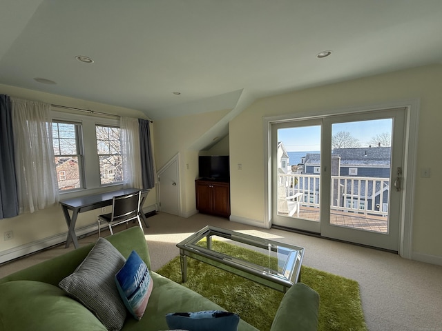 carpeted living room featuring baseboards, a wealth of natural light, and recessed lighting