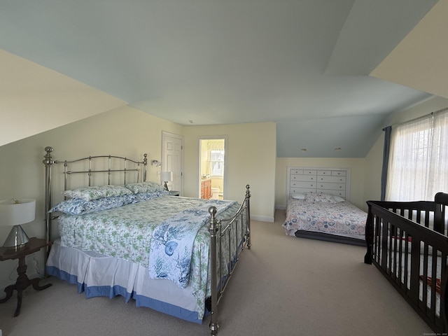 carpeted bedroom featuring vaulted ceiling