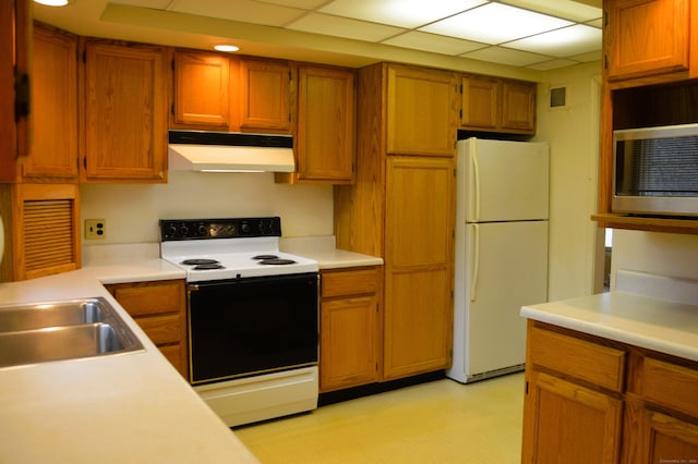 kitchen featuring brown cabinets, light floors, light countertops, white appliances, and under cabinet range hood