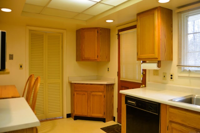 kitchen with brown cabinets, black dishwasher, light countertops, and recessed lighting