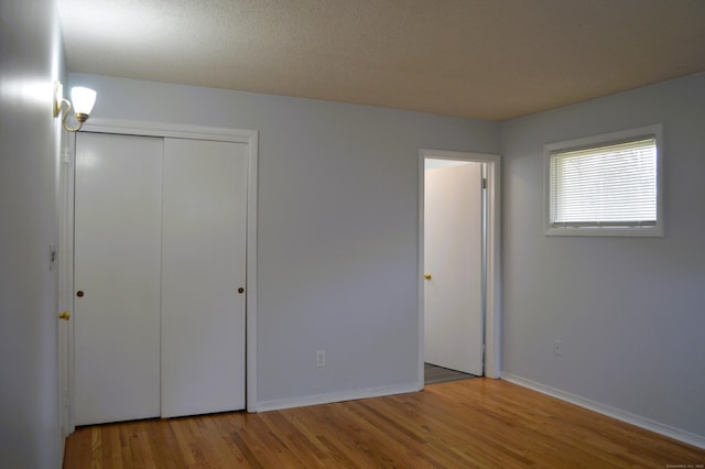 unfurnished bedroom featuring baseboards and wood finished floors