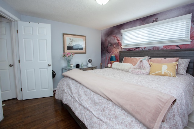 bedroom featuring a textured ceiling and wood finished floors