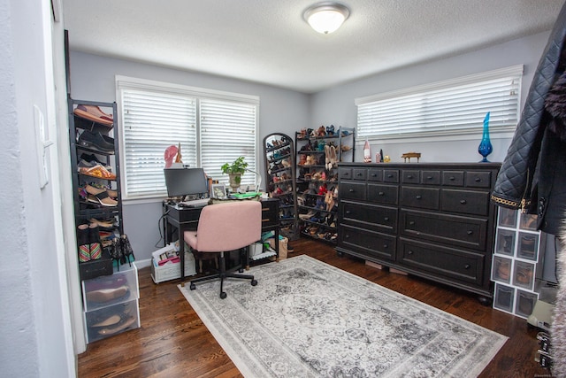 office featuring dark wood-type flooring and a textured ceiling