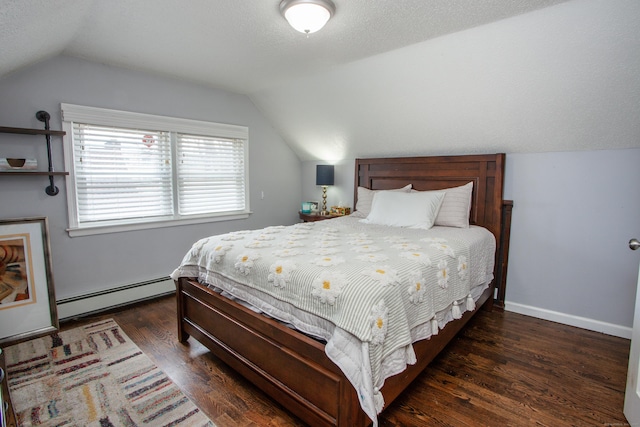 bedroom with a baseboard heating unit, a textured ceiling, wood finished floors, and lofted ceiling