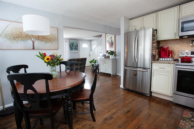 dining room with stairs, dark wood-style flooring, a textured ceiling, and baseboards