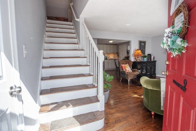 staircase with wood finished floors