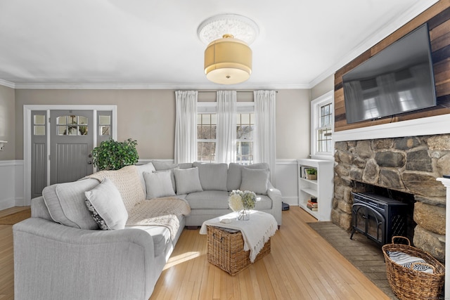 living area with ornamental molding and hardwood / wood-style flooring