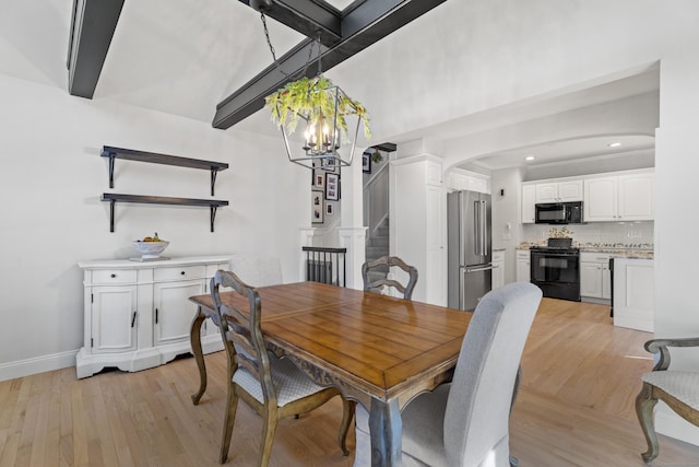 dining area with beamed ceiling, a notable chandelier, arched walkways, light wood-style floors, and stairs