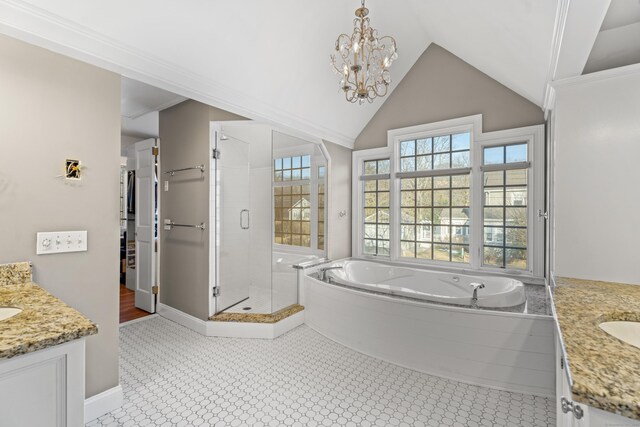 full bathroom featuring a garden tub, two vanities, a stall shower, and lofted ceiling