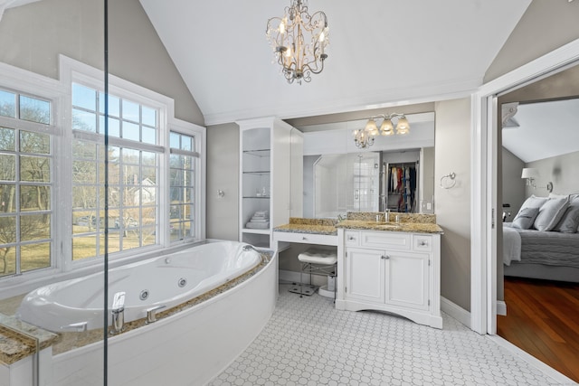 bathroom featuring connected bathroom, a chandelier, and vaulted ceiling