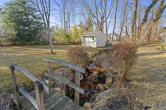 view of yard with an outdoor structure, fence, and a shed