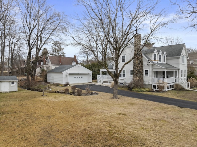 view of yard with an outbuilding and covered porch