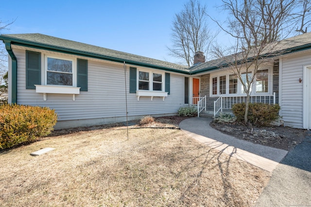 single story home with a porch and a chimney