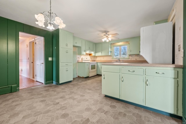 kitchen featuring under cabinet range hood, a sink, electric stove, and green cabinetry