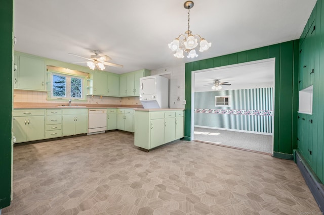 kitchen featuring dishwasher, light countertops, green cabinets, and a sink