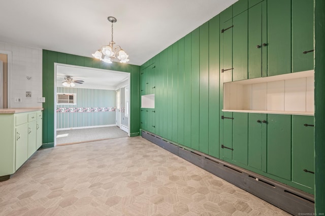 interior space with baseboard heating, ceiling fan with notable chandelier, and baseboards