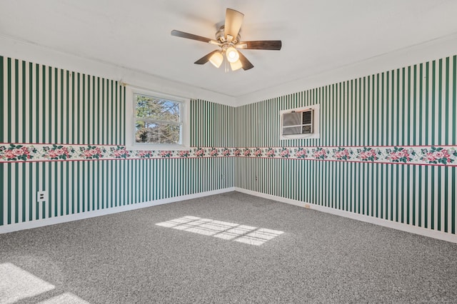 unfurnished room featuring an AC wall unit, baseboards, carpet floors, and ceiling fan