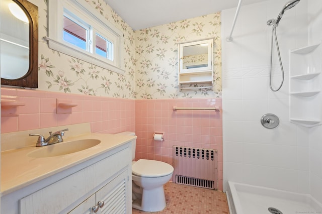 full bathroom featuring wallpapered walls, radiator heating unit, a shower stall, wainscoting, and toilet