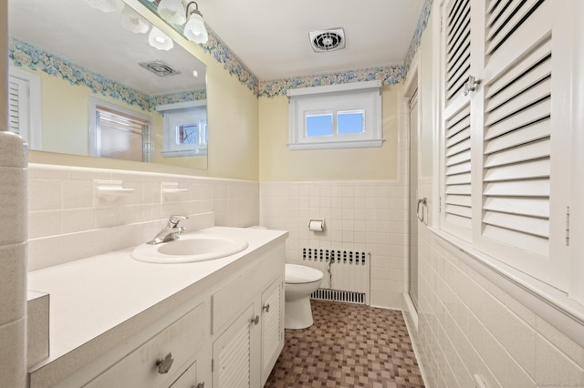 full bath featuring toilet, tile walls, radiator, and visible vents