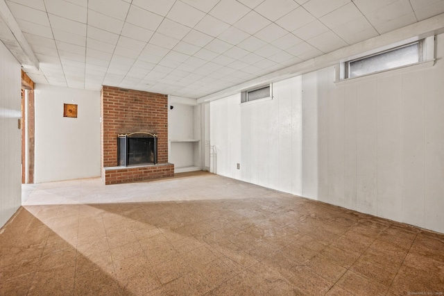 unfurnished living room with tile patterned floors and a brick fireplace